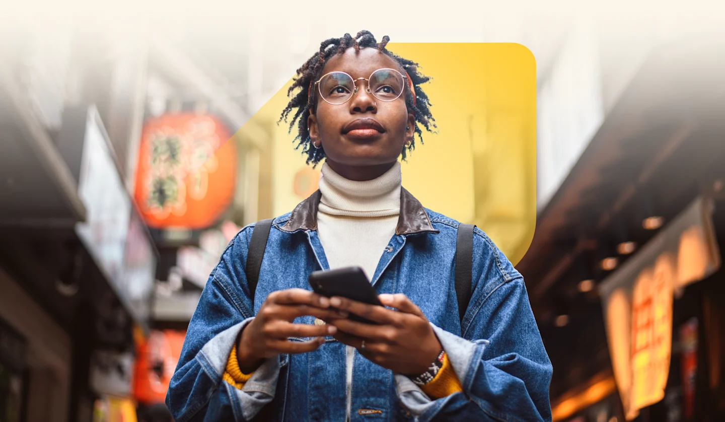 Photo of a smiling woman looking upward with phone in hand, surrounded by text describing what EQ Bank offers: high interest, unlimited transactions and no monthly fees, with EQ Bank jewel symbol set against city backdrop.